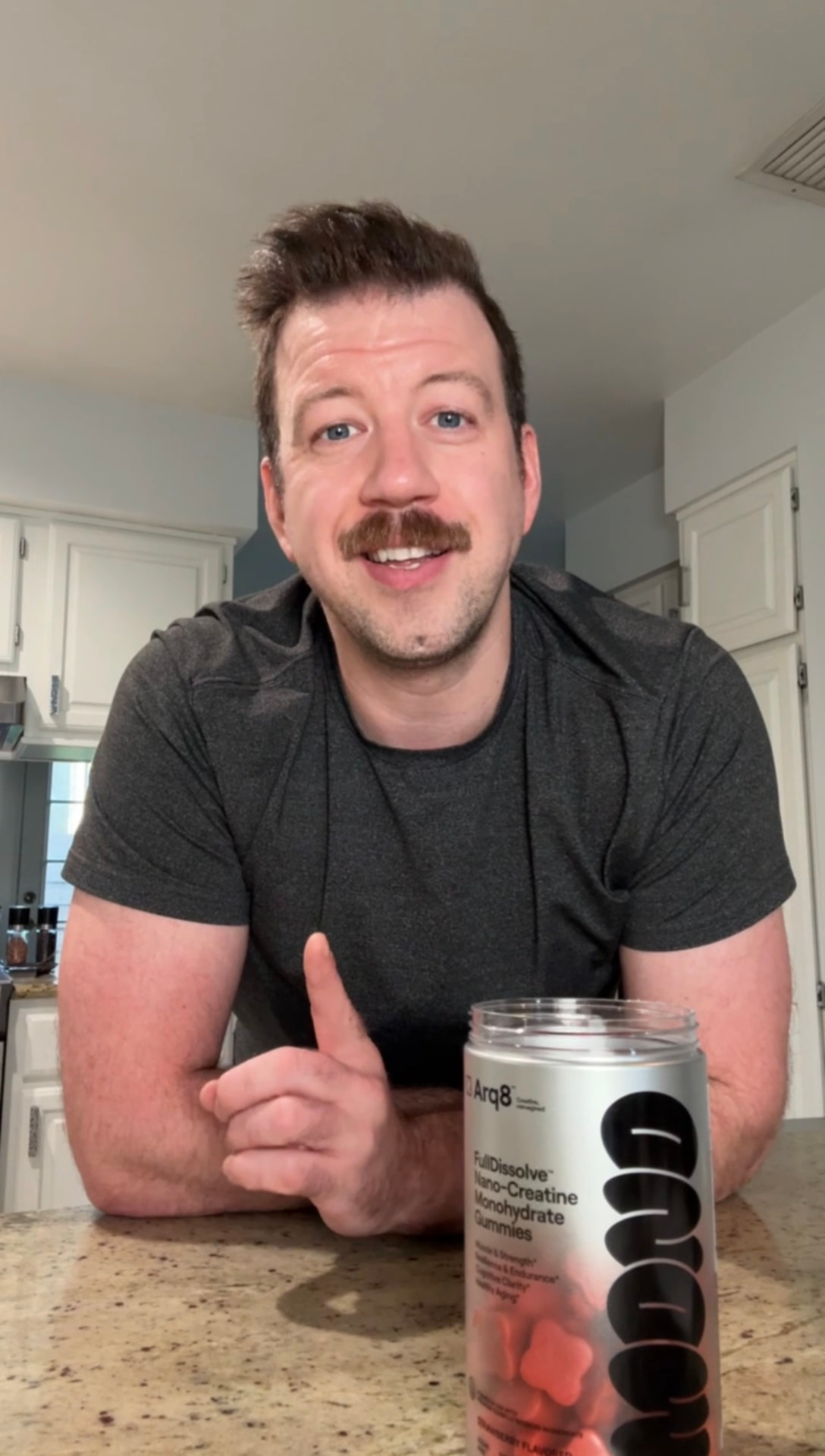 Tim MacDonald filming a UGC testimonial for Arq8 creatine gummies in his kitchen
